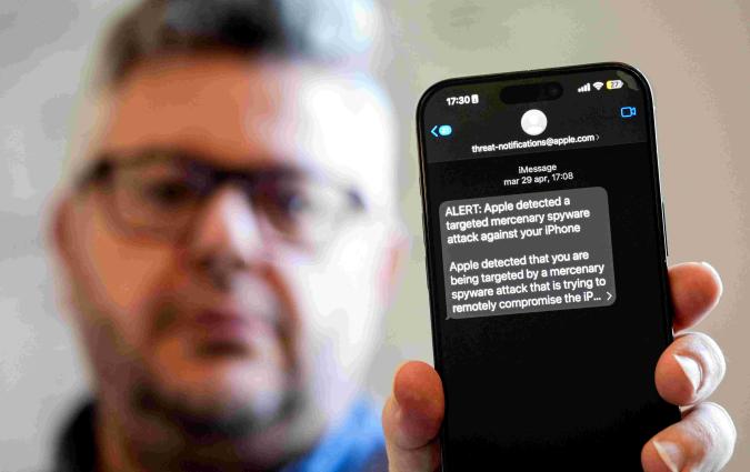 Ciro Pellegrino shows his phone screen displaying a threat notification from Apple warning of a mercenary spyware attack