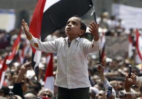 A boy prays during a demonstration at Tahrir Square in Cairo April 1, 2011