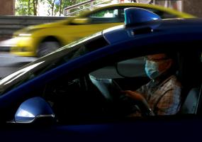 man reads newspaper in taxi
