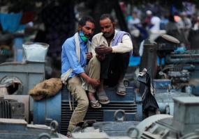 Men look at a mobile phone in Delhi, India, November 2020. REUTERS/Adnan Abidi