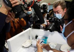 A nurse prepares a dose of the Pfizer-BioNTech COVID-19 vaccine, surrounded by media staff, Bobigny, France, December 30, 2020. REUTERS/Charles Platiau