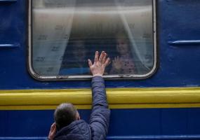 Children look out from an evacuation train from Kyiv to Lviv as they say goodbye to their father at Kyiv central train station in central Kyiv, Ukraine March 3, 2022. REUTERS/Gleb Garanich