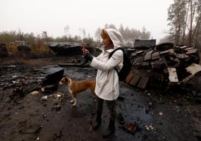 Iryna Vereshchagina, films with her mobile phone Russian destroyed tanks and armoured vehicles, amid Russia's invasion of Ukraine in Dmytrivka village, west of Kyiv, Ukraine April 1, 2022. REUTERS/Zohra Bensemra